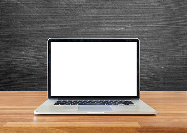 Laptop on table, on  blackboard background,blank screen